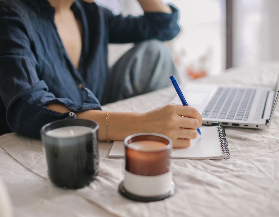 Image of woman taking notes from her laptop