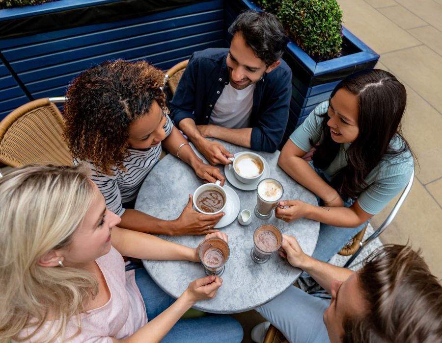 Image of group having coffee at outdoor cafe table