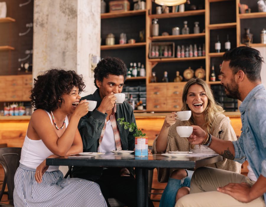 Group laughing together at cafe